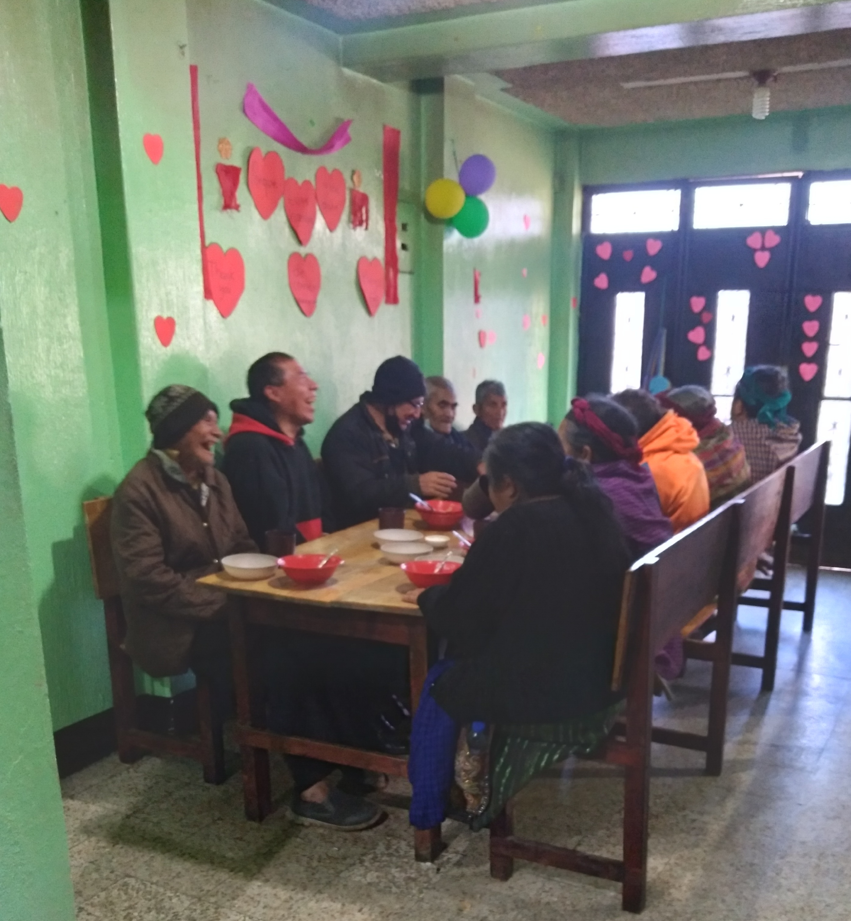 Elderly in Guatemala enjoying a meal at Cosechando's headquarters.