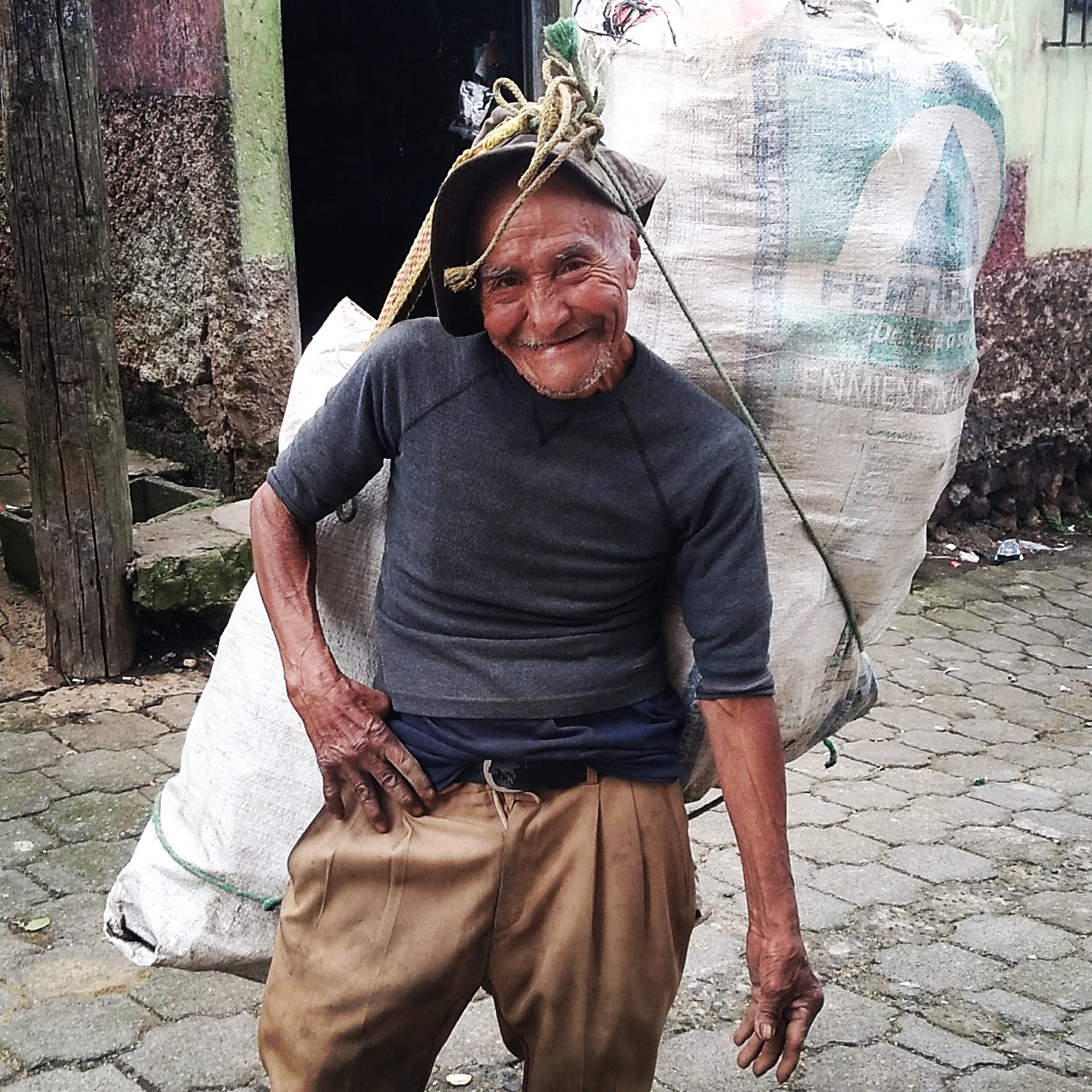 A man carrying a bag of trash.