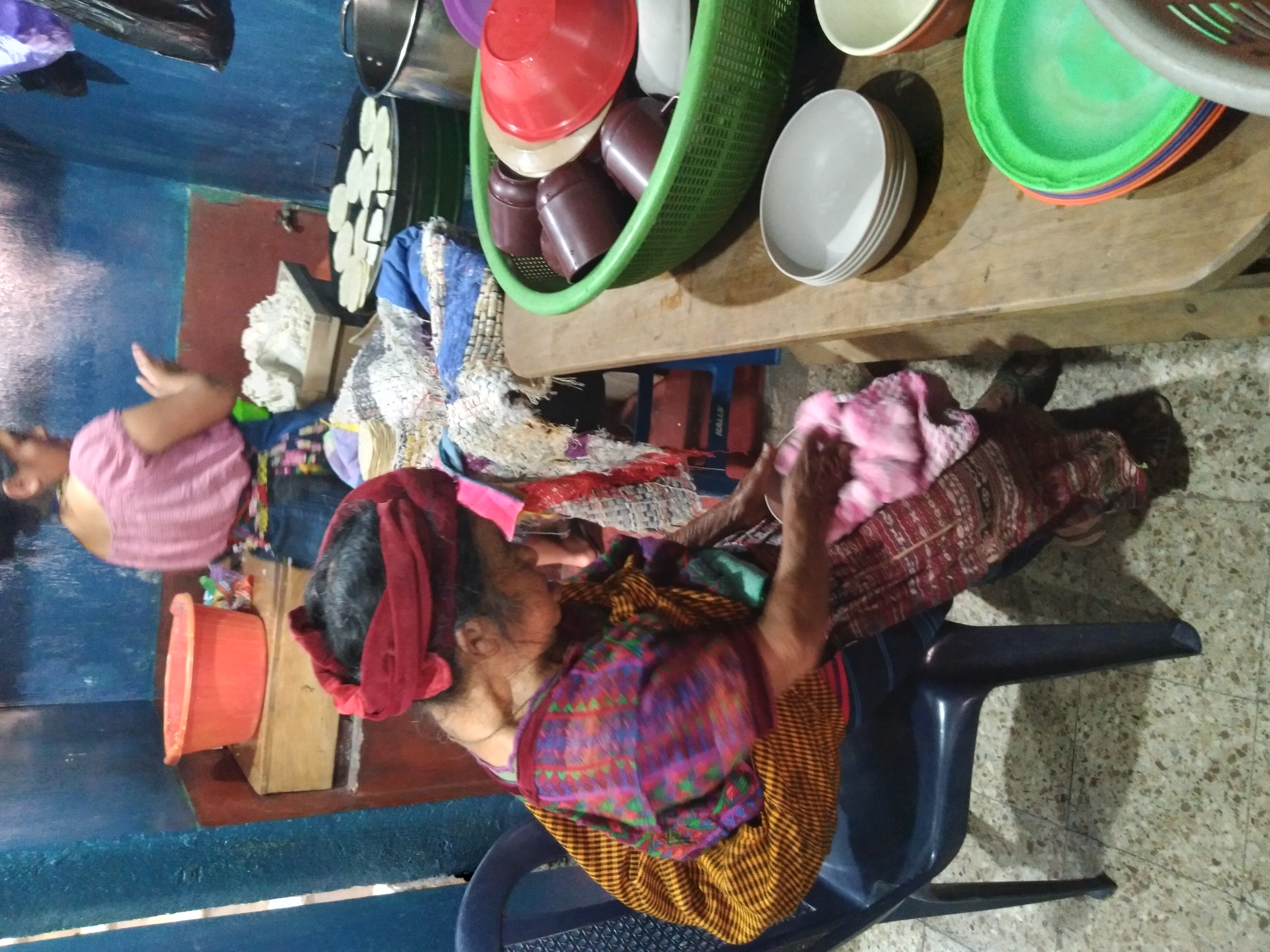 An abuela cleaning dishes.