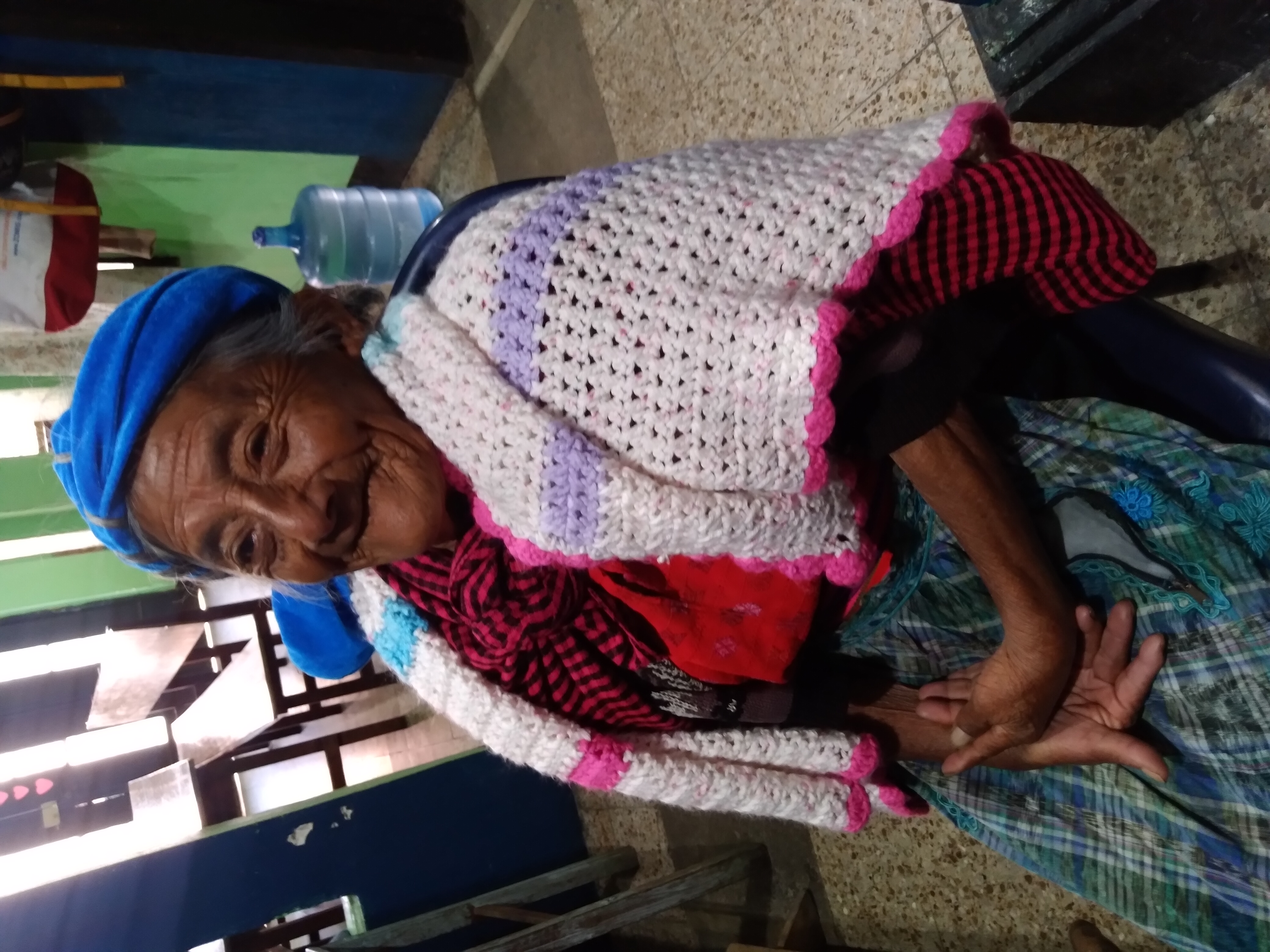 An elder woman smiling.