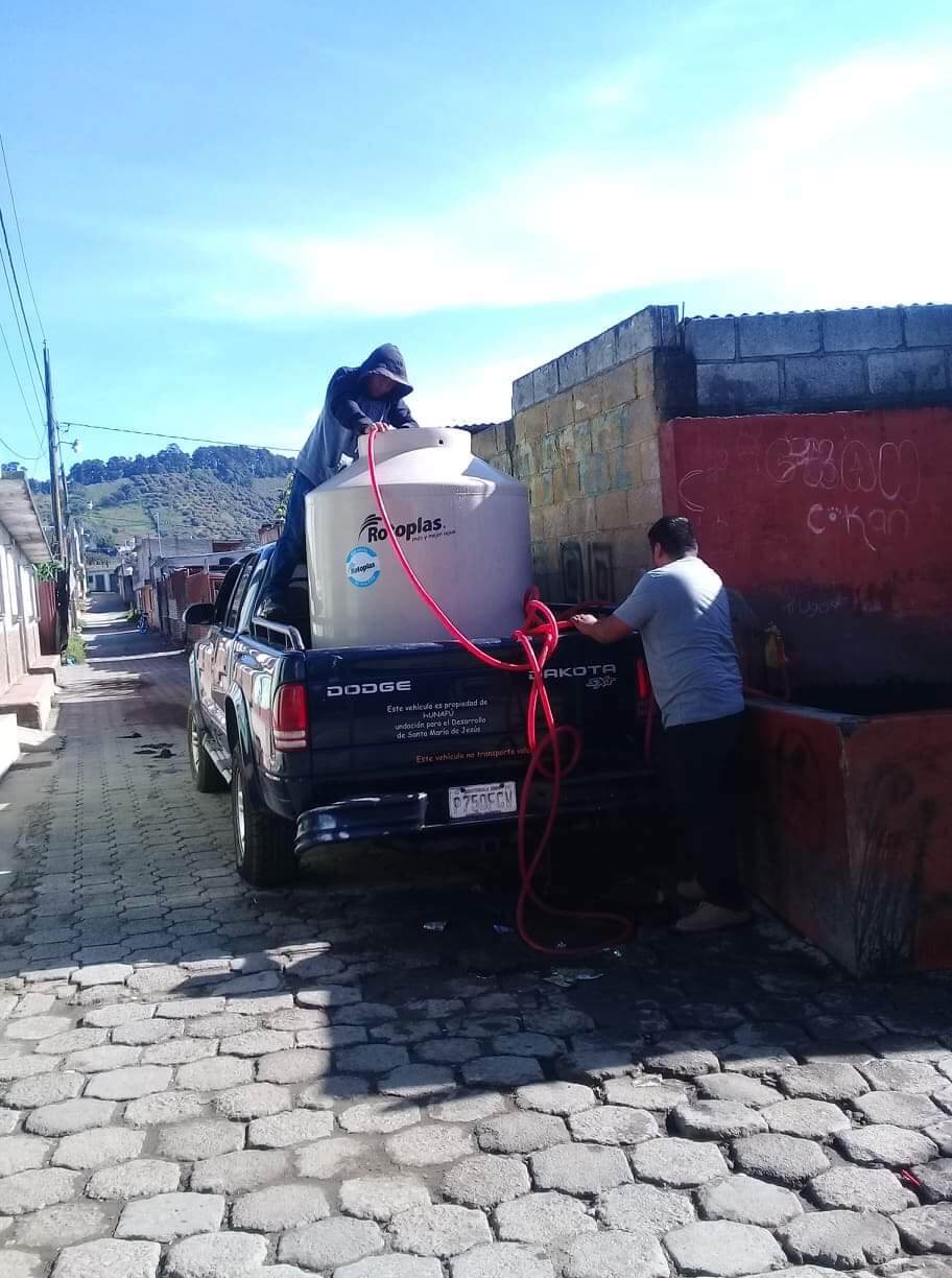 Collecting water to bring back to the project since the pipe burst in our section of town.