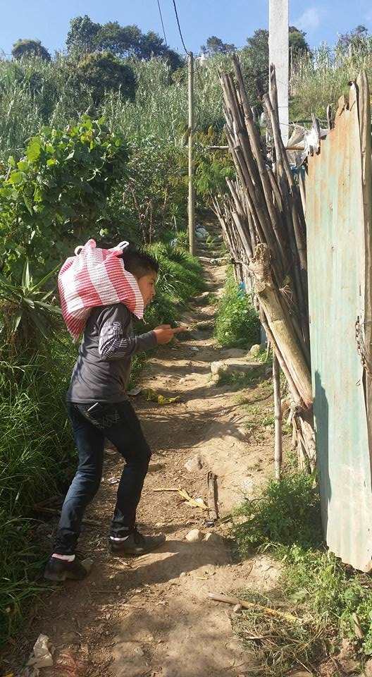 Guatemalan boy carrying food.